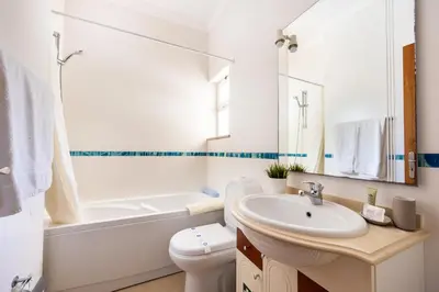 a white bathroom with a sink and a toilet at CoolHouses Algarve Luz, 5 bed villa & pool, Casa N in Luz