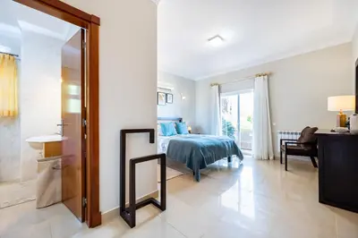 a bedroom with a bed and a mirror at CoolHouses Algarve Luz, 5 bed villa & pool, Casa N in Luz