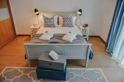 a bedroom with a bed with two pillows on it at Quinta do Brasil in Arco da Calheta