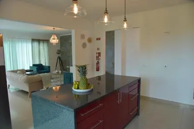 a kitchen with a island in a living room at Quinta do Brasil in Arco da Calheta