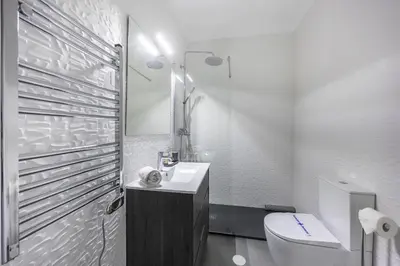 a white bathroom with a toilet and a sink at CoolHouses Algarve Luz, 1 bed penthouse flat w/ sea views. Fiji 11 in Luz