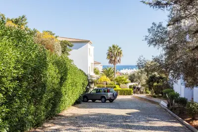 a car parked on a street next to a hedge at CoolHouses Algarve Luz, 1 bed penthouse flat w/ sea views. Fiji 11 in Luz