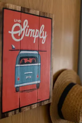 a picture of a painting of a suitcase on a wall at Lemon Tree Apartment in Luz
