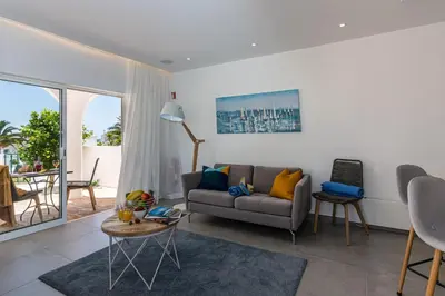 a living room with a couch and a table at Lemon Tree Apartment in Luz