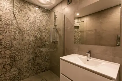 a bathroom with a sink and a shower at Lemon Tree Apartment in Luz