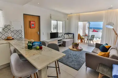 a living room with a kitchen and a living room at Lemon Tree Apartment in Luz