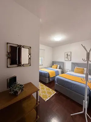 a room with two beds and a television in it at Casa 212 in Ponta do Sol
