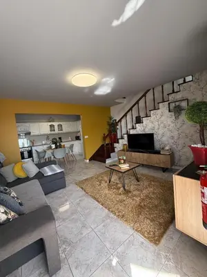 a living room with a couch and a table at Casa 212 in Ponta do Sol
