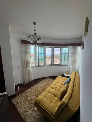 a bedroom with a large bed in a room with windows at Casa 212 in Ponta do Sol