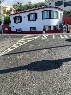 a shadow of a man on a street in front of a house at Casa 212 in Ponta do Sol
