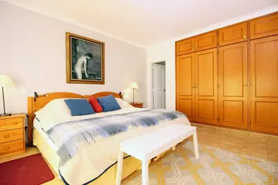 a bedroom with a bed and a table in it at Bright and central apartment - Praia da Luz in Luz