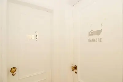 a white door with a sign on it at Bright and central apartment - Praia da Luz in Luz