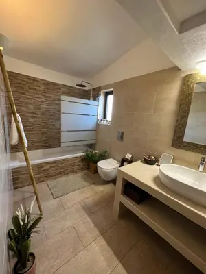 a bathroom with a sink and a toilet and a tub at Casa Canavial in Lagos
