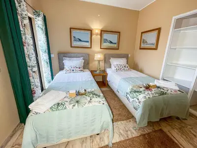 two beds sitting next to each other in a room at Casa Canavial in Lagos