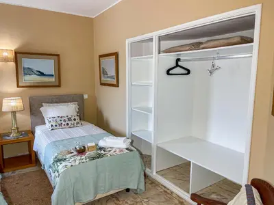 a bedroom with a bed and a book shelf at Casa Canavial in Lagos