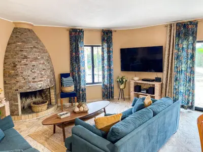 a living room with a blue couch and a fireplace at Casa Canavial in Lagos