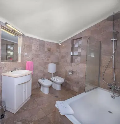 a bathroom with a tub and a sink and a toilet at Sunny Seaside 1 bedroom apartment in Praia da Luz in Luz