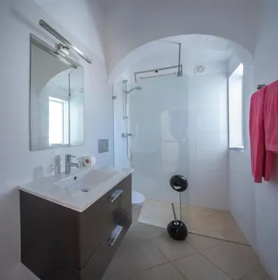 a white bathroom with a sink and a shower at Sunny Seaside 1 bedroom apartment in Praia da Luz in Luz