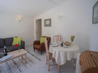 a living room with a table and a couch at Sunny Seaside 1 bedroom apartment in Praia da Luz in Luz