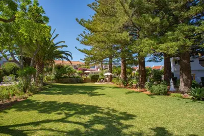 a large yard with trees and grass at Sunny Seaside 1 bedroom apartment in Praia da Luz in Luz