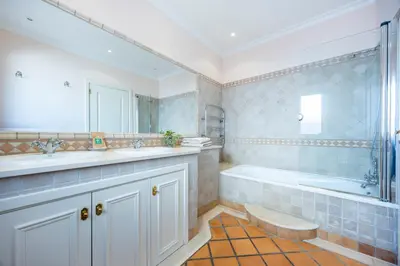 a bathroom with a tub and a sink and a shower at Casa Gribouille in Sagres