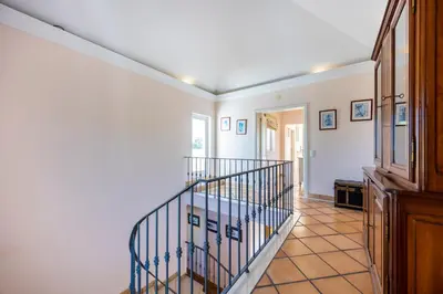 a hallway with a spiral staircase in a home at Casa Gribouille in Sagres