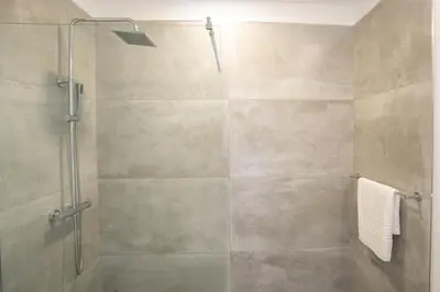 a shower stall with a glass door in a bathroom at CASA GEORGINA in Calheta