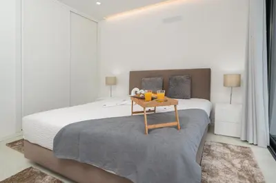 a bedroom with a bed with a table with two oranges on it at CASA GEORGINA in Calheta