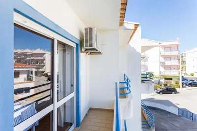 a balcony with a view of a street at CoolHouses Algarve Luz, 2 Bed top floor flat, amazing sea view, central. Delicia do Sol in Luz