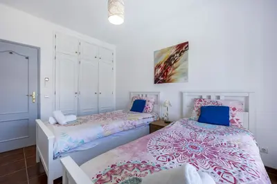two beds in a room with white walls at CoolHouses Algarve Luz, 2 Bed top floor flat, amazing sea view, central. Delicia do Sol in Luz