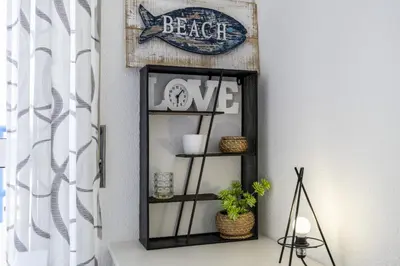 a shelf in a room with a beer sign and plants at CoolHouses Algarve Luz, 2 Bed top floor flat, amazing sea view, central. Delicia do Sol in Luz