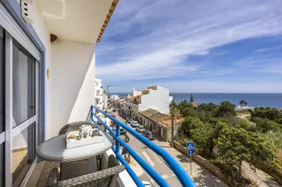 a balcony with a view of the ocean at CoolHouses Algarve Luz, 2 Bed top floor flat, amazing sea view, central. Delicia do Sol in Luz