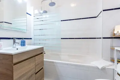 a bathroom with a tub and a sink and a shower at CoolHouses Algarve Luz, 2 Bed top floor flat, amazing sea view, central. Delicia do Sol in Luz