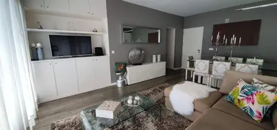 a living room with a couch and a tv at Casa da Rocha in Paul do Mar