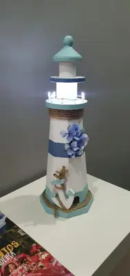 a cake with a lighthouse on top of a table at Casa da Rocha in Paul do Mar