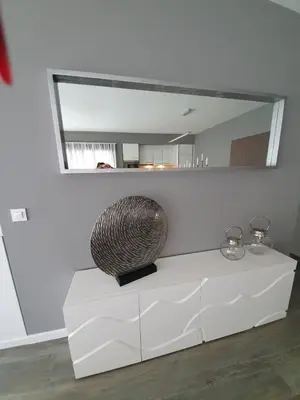 a vase sitting on a white table in front of a mirror at Casa da Rocha in Paul do Mar