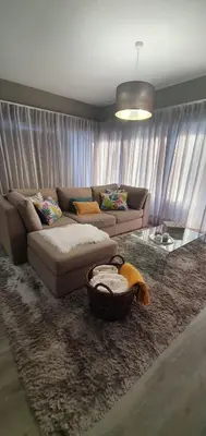 a living room with a couch and a table at Casa da Rocha in Paul do Mar