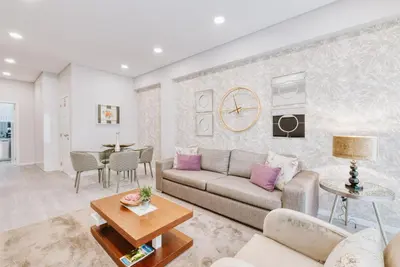 a living room with a couch and a table at Madeira Xhic Apartment by Amazing Madeira in Funchal