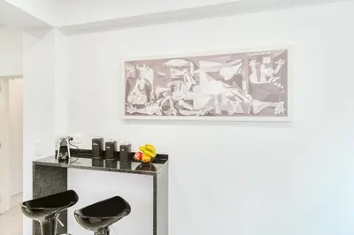 a room with two stools and a painting on the wall at Madeira Xhic Apartment by Amazing Madeira in Funchal