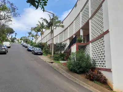 a street with cars parked on the side of a building at Apartamentos Matur Flats 2 in Machico