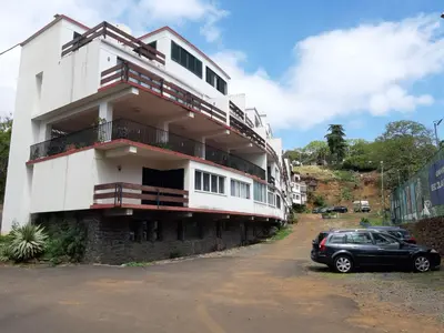 a building with a car parked in front of it at Apartamentos Matur Flats 2 in Machico