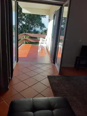 a living room with a couch and a balcony at Apartamentos Matur Flats 2 in Machico