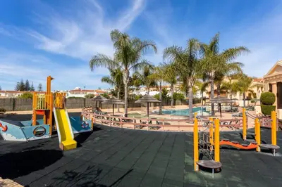 a playground at a resort with a slide at Baia da Luz- ground floor apartment in Luz