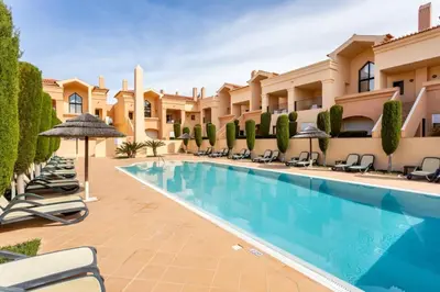 a pool in the courtyard of a villa at Baia da Luz- ground floor apartment in Luz