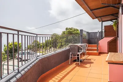 a balcony with a table and chairs on it at Casa do Miradouro -Fantástico Estúdio in Santa Cruz