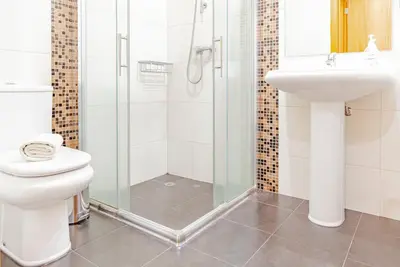 a bathroom with a shower and a toilet and a sink at Harmony Apartment in Funchal