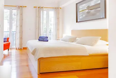 a bedroom with a large bed with a teddy bear on it at Harmony Apartment in Funchal