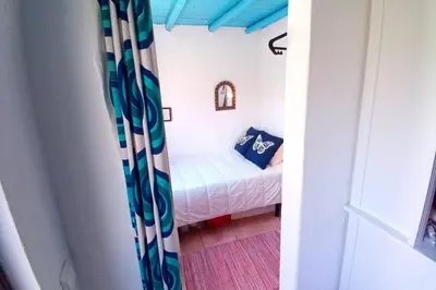 a small bedroom with a small bed in a room at Casinha de Aldeia no coração da Costa Vicentina in Vila do Bispo