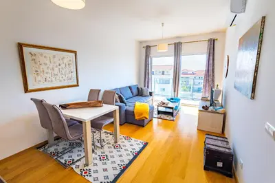 a living room with a table and a couch at Sun and Sea II in Caniço