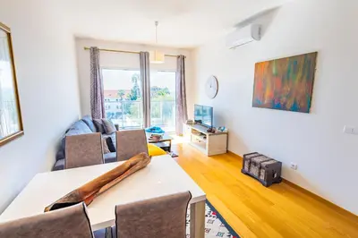 a living room with a table and chairs at Sun and Sea II in Caniço